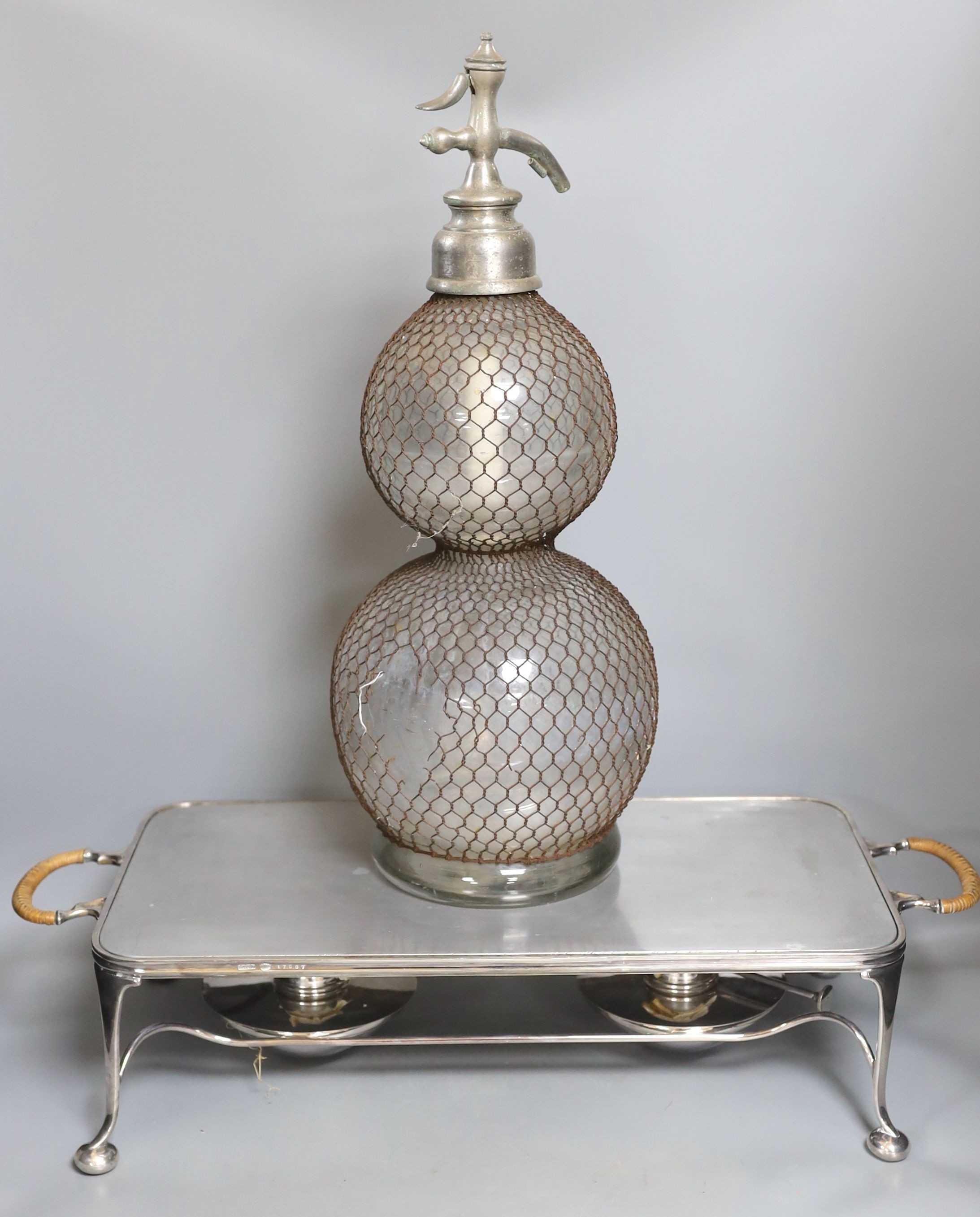 An Asprey two handled hot plate and a double gourd shaped soda stream, 50 cms high.